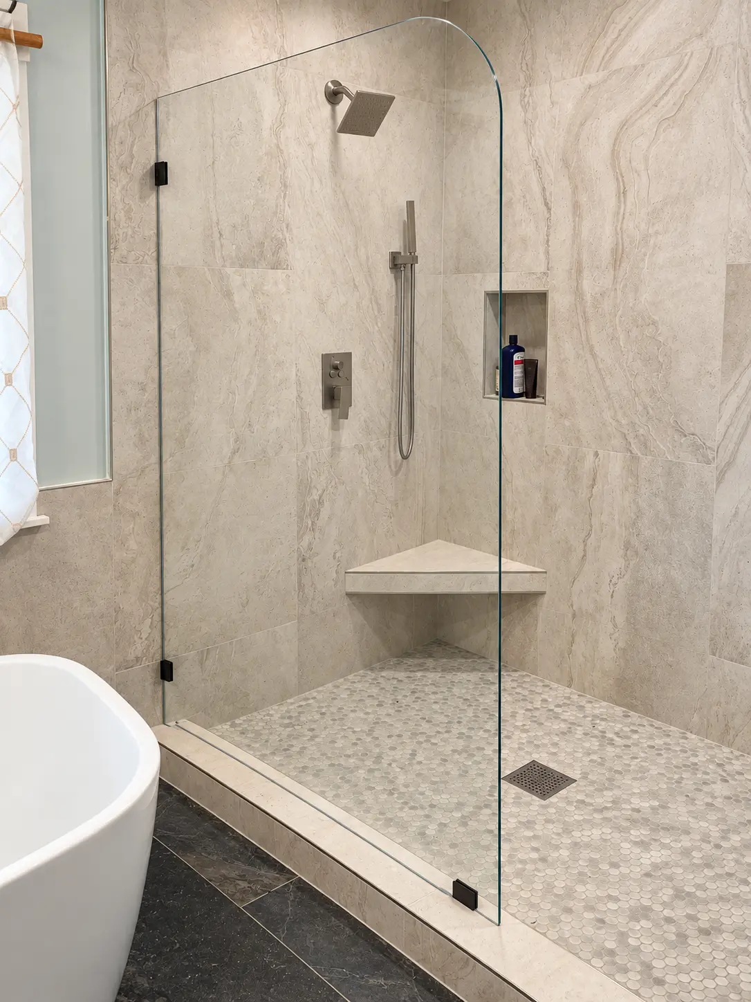 Finished tiled shower with glass enclosure