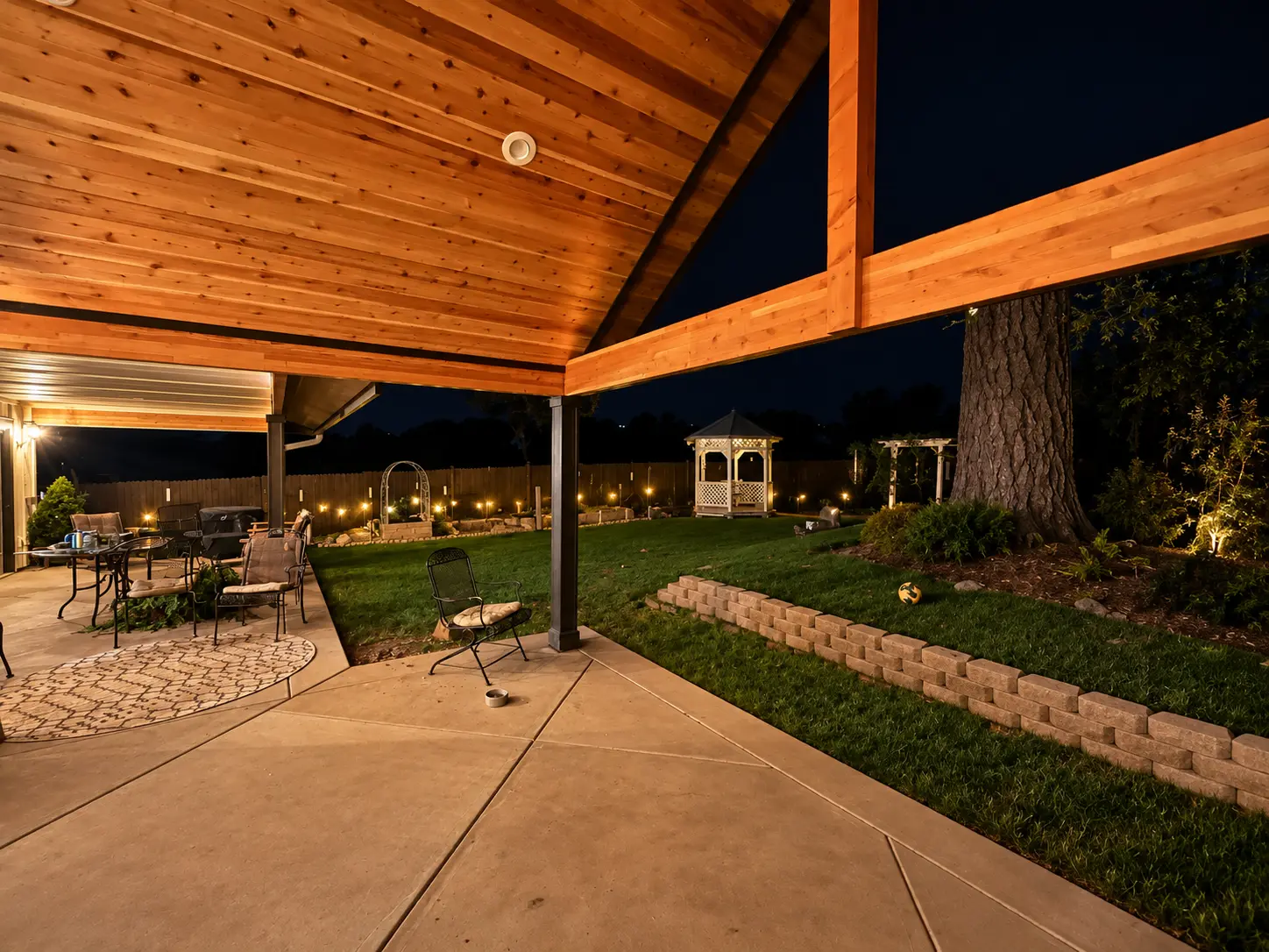 Covered patio with warm exterior lighting